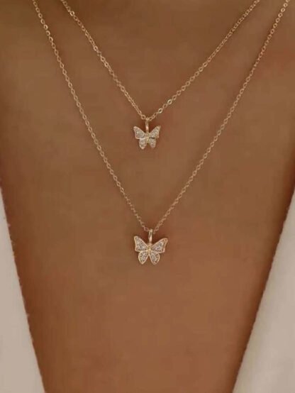 Collier multirangs papillon strass or rose